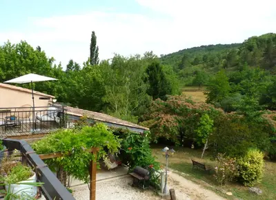 a garden with a bench and a tree at Gîte de Lamourade in Saint-Ferriol