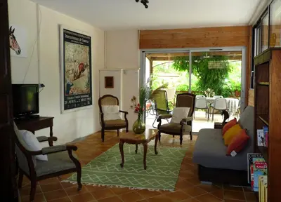 a living room with a table and chairs at Gîte de Lamourade in Saint-Ferriol