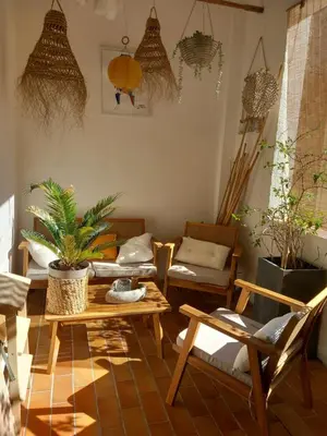 a living room with tables and chairs and plants at Appartement au coeur du centre historique in Narbonne