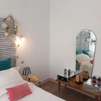 a bedroom with a bed and a mirror at Appartement au coeur du centre historique in Narbonne