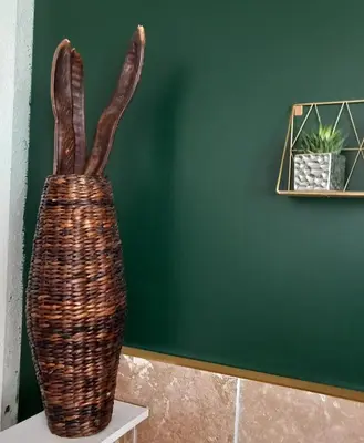a wicker vase sitting on a table next to a wall at Appartement au coeur du centre historique in Narbonne