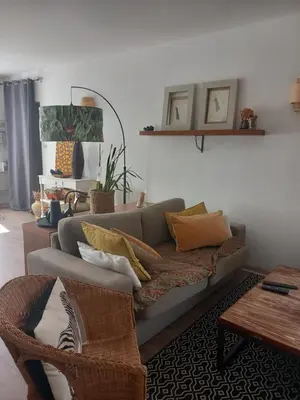 a living room with a couch and a table at Appartement au coeur du centre historique in Narbonne