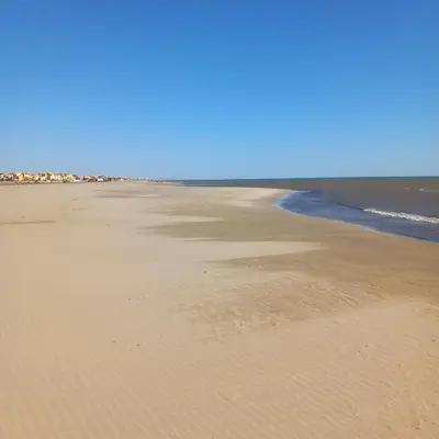 an empty beach with the ocean in the background at Appartement au coeur du centre historique in Narbonne