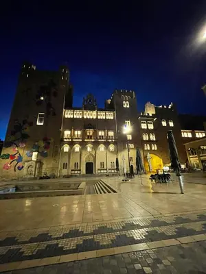 a large building with a courtyard at night at Appartement au coeur du centre historique in Narbonne