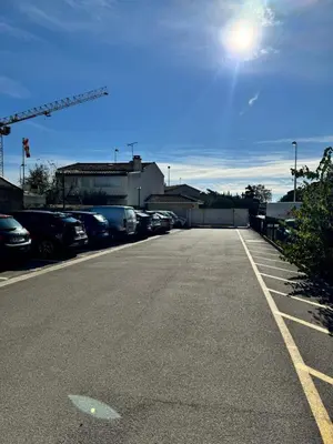a parking lot with a lot of cars parked at Narb'home, Cosy , Parking, Balcon in Narbonne
