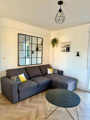 a living room with a couch and a table at Narb'home, Cosy , Parking, Balcon in Narbonne