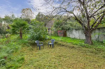 two chairs and a table in a yard at L'Écrin de Pamiers - Appt climatisé pour 6 in Pamiers
