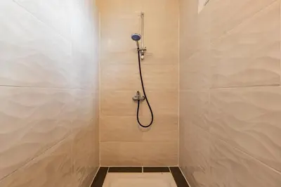 a bathroom with a shower with a toilet in it at L'Écrin de Pamiers - Appt climatisé pour 6 in Pamiers