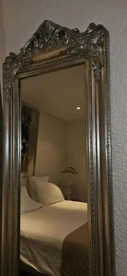 a mirror reflecting a bed in a bedroom at Le Clos Saint Jean, vue Cité, piscine et parking in Carcassonne