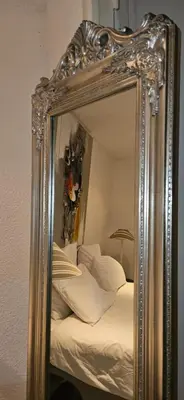a mirror reflecting a bed with white pillows at Le Clos Saint Jean, vue Cité, piscine et parking in Carcassonne