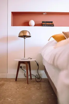 a lamp on a table next to a bed at Chambre tout confort à l'Héritier - au coeur du Tarn in Marzens