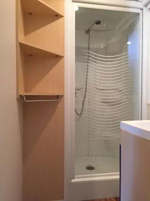 a shower with a glass door in a bathroom at Mobilhome Ferme équestre La Mouillère in Chalabre