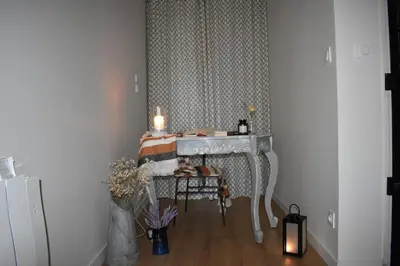 a room with a sink and a table with candles at La Vue de Manuel in Carcassonne