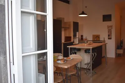 a kitchen with a counter and a table and a counter top at La Vue de Manuel in Carcassonne