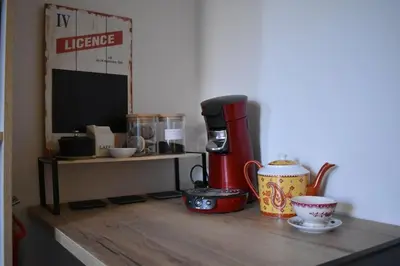a kitchen counter with a coffee maker and cups on it at La Vue de Manuel in Carcassonne