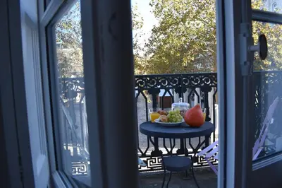 a table with a bowl of fruit on a balcony at La Vue de Manuel in Carcassonne
