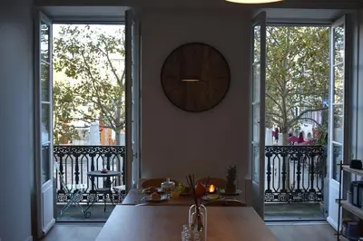 a kitchen with a table and a clock on the wall at La Vue de Manuel in Carcassonne