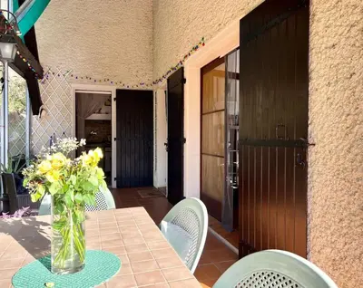 a vase of flowers on a table with chairs at Belle Villa 4 bed, sud de la France in Limoux
