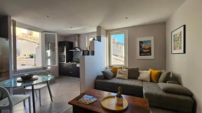 a living room with a couch and a table at Appartement PETIT SAINT GIMER in Carcassonne