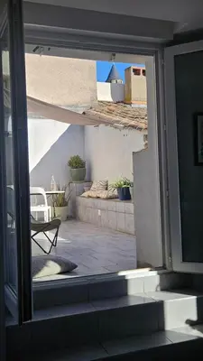 a view of a patio from an open window at Appartement PETIT SAINT GIMER in Carcassonne