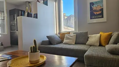 a living room with a couch and a table at Appartement PETIT SAINT GIMER in Carcassonne