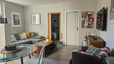 a living room with a couch and a table at Appartement PETIT SAINT GIMER in Carcassonne