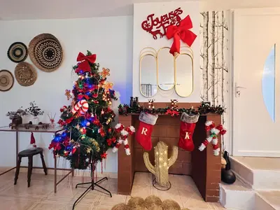 a living room with a christmas tree and a fireplace at Maison de vacances spa in Narbonne