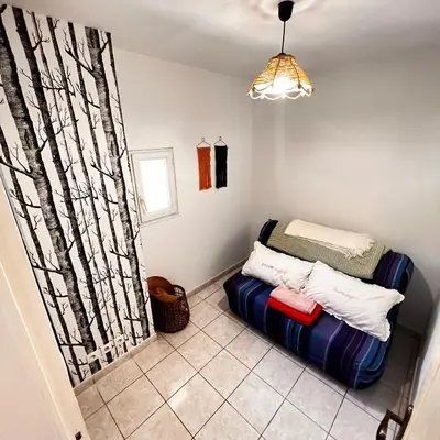a room with a bed in a room with a window at Maison de vacances spa in Narbonne