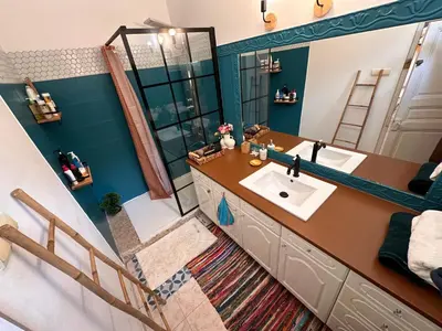 a bathroom with a sink and a mirror at Maison de vacances spa in Narbonne