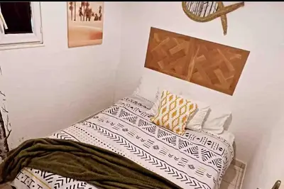 a small bedroom with a bed with pillows on it at Maison de vacances spa in Narbonne