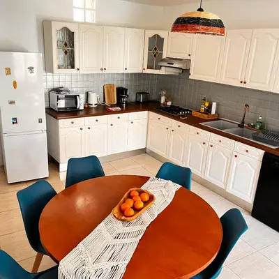 a kitchen with a table with a bowl of oranges on it at Maison de vacances spa in Narbonne