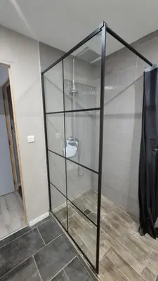 a glass shower stall with a toilet in a room at l'instant cosy in Tuchan