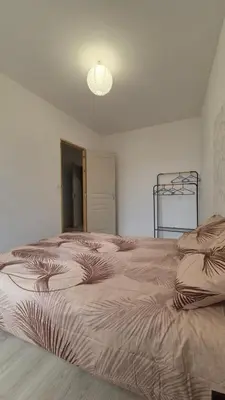 a bedroom with a large bed with a bed sqor at l'instant cosy in Tuchan