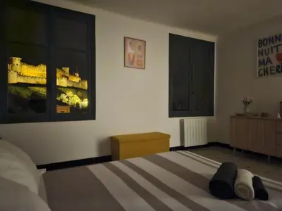 a bedroom with a bed with two shoes on it at Vue Cité Médiévale Castel View in Carcassonne