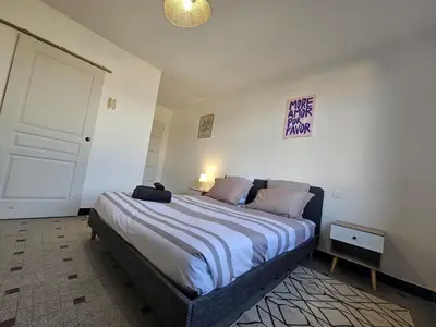 a bedroom with a large bed in a room at Vue Cité Médiévale Castel View in Carcassonne