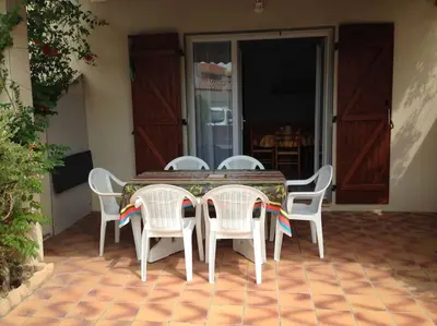 a table and chairs sitting on a patio at Maison 6 personnes plage à 5min in Port-la-Nouvelle