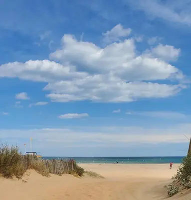 a sandy beach with a blue sky and the ocean at Le Segarius superbe maison médiévale Internet WiFi gratuit Climatisation Jardin in Puisserguier