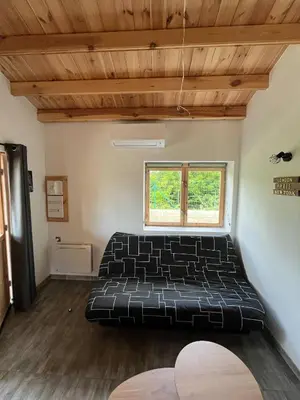 a bedroom with a black bed in a room at Chalet détente in Montaut