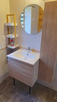 a bathroom with a sink and a mirror at Chalet détente in Montaut