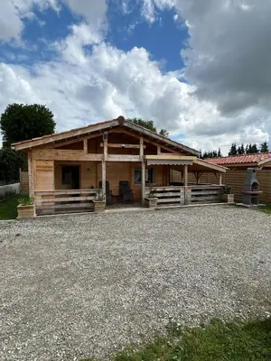a log cabin with a porch and a roof at Chalet détente in Montaut
