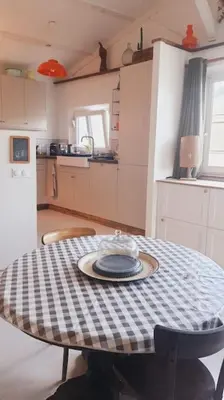 a kitchen with a table with a plate on it at Chalet - Beach House in Gruissan