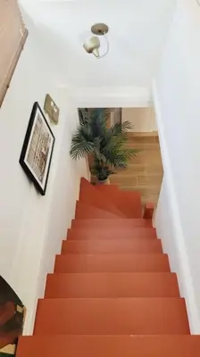 an orange staircase with a potted plant on it at Chalet - Beach House in Gruissan