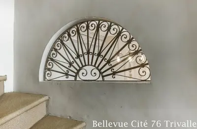 a metal object on a wall next to some stairs at Les Bellevue Cité Trivalle 