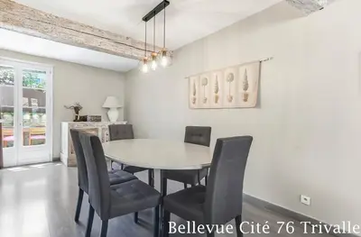 a dining room with a table and chairs at Les Bellevue Cité Trivalle 
