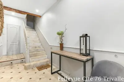 a living room with stairs and a table at Les Bellevue Cité Trivalle 