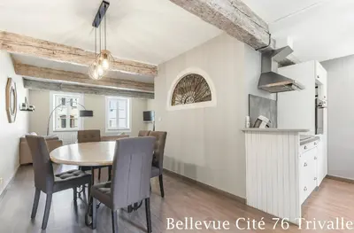a kitchen and dining room with a table and chairs at Les Bellevue Cité Trivalle 