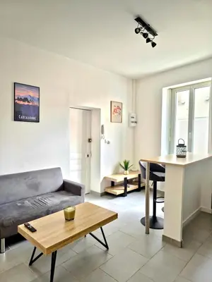 a living room with a couch and a table at Tour Ouest - T2 entre Cité Médiévale et Bastide in Carcassonne