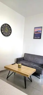 a living room with a couch and a coffee table at Tour Ouest - T2 entre Cité Médiévale et Bastide in Carcassonne