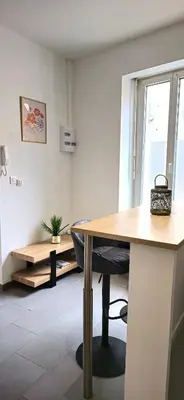 an office with a wooden desk and a chair at Tour Ouest - T2 entre Cité Médiévale et Bastide in Carcassonne
