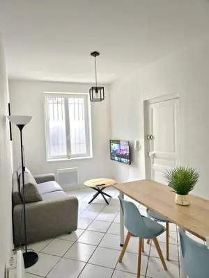 a living room with a couch and a table at Tour Est - T2 entre Cité Médiévale et Bastide in Carcassonne